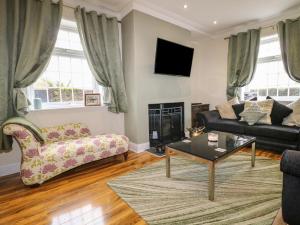 a living room with a couch and a coffee table at Bankside House in Melton Mowbray