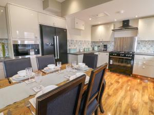 a kitchen with a table and chairs and a kitchen with appliances at Bankside House in Melton Mowbray