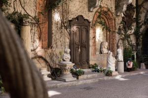 a stone building with statues in front of a door at Atellani Apartments in Milan