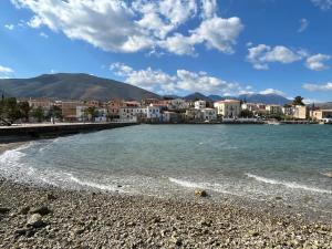 a view of a beach with buildings and the water at Galaxidi Sea View Apartment , Galaxidi in Galaxidhion