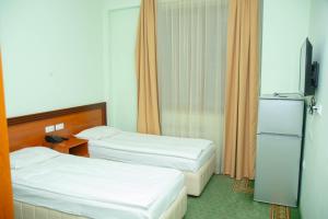 Voodi või voodid majutusasutuse Olympavan Hotel toas