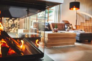 a living room with a fire oven in a living room at ATEMPAUSE Sauerland in Schmallenberg