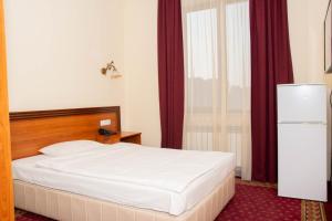 Voodi või voodid majutusasutuse Olympavan Hotel toas