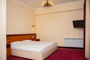 Voodi või voodid majutusasutuse Olympavan Hotel toas