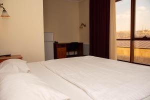 Voodi või voodid majutusasutuse Olympavan Hotel toas