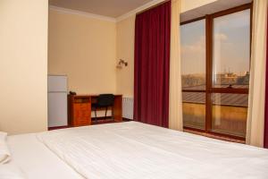 Voodi või voodid majutusasutuse Olympavan Hotel toas