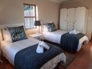 En eller flere senge i et værelse på Nieuwedrift accommodation
