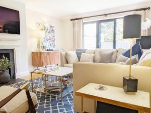 a living room with a couch and a fireplace at Steddles - Chichester in Chichester