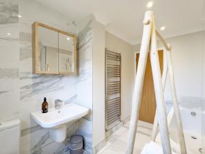 a white bathroom with a sink and a tub at Steddles - Chichester in Chichester +41 photos