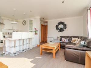 a living room with a leather couch and a table at 2 Bedroom Annexe in Morecambe