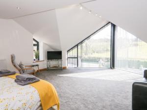 a bedroom with a bed and a large window at The Annexe in Llanfairpwllgwyngyll