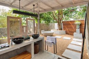 a bathroom with two sinks and a bath tub at Haritha Villas & Spa in Hikkaduwa