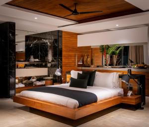a bedroom with a large bed in a room at Haritha Villas & Spa in Hikkaduwa