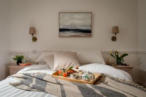 a tray of food on top of a bed at Uphigh - Elevated Family Home with Stunning River Views in Dartmouth