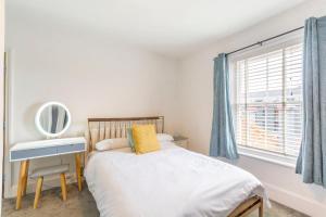 a bedroom with a bed and a mirror and a window at Minster Hub - 2 Min Walk 2 Minster! in York