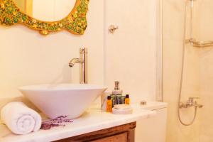 a bathroom with a white sink and a shower at Fidanka Hotel in Kalkan