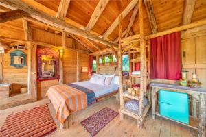 a bedroom in a log cabin with a bed at Fidanka Hotel in Kalkan