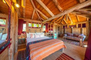a bedroom with a bed in a wooden cabin at Fidanka Hotel in Kalkan