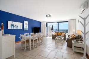 a kitchen and living room with a table and chairs at Malvasia 22 in Puerto Calero