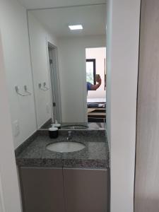 a person taking a picture of a bathroom sink at Condomínio Paraiso dos Coqueiros in Camaçari