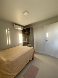 a bedroom with a large bed and a closet at Condomínio Paraiso dos Coqueiros in Camacari +19 photos
