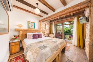 a bedroom with a bed and a window at Fidanka Hotel in Kalkan