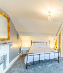 a bedroom with a bed with a mirror and a chandelier at Minster Hub - 2 Min Walk 2 Minster! in York