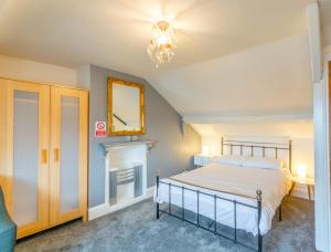 a bedroom with a bed and a mirror and a fireplace at Minster Hub - 2 Min Walk 2 Minster! in York