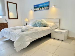 a bedroom with a large bed with white sheets at Comfortable seaside apartment in Salou - 85 m² - Sea view in Salou