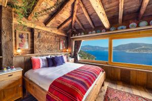 a bedroom with a bed in a room with a window at Fidanka Hotel in Kalkan