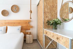 a room with a bed and a mirror at Blue Harbour Boutique in Ayia Napa