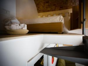 a room with a bed on top of a shelf at San Giovanni Vecchio - Residenza in Matera