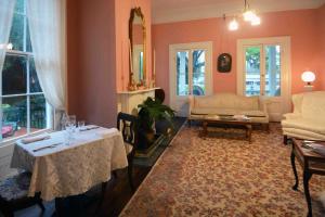 a living room with a table and a couch at 1872 Denham Inn in Monticello
