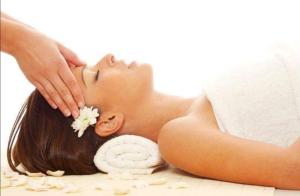 a woman laying on the floor getting a massage at Domaine de la Fauvriere in Sainte-Honorine-de-Ducy