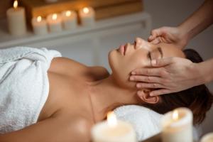 a woman getting a massage in a towel at Domaine de la Fauvriere in Sainte-Honorine-de-Ducy