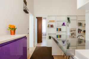 uma cozinha com armários roxos e brancos e um lavatório em Allo Squero em Veneza