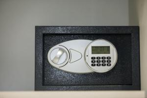a microwave with a clock on top of it at Bourbon Boutique Hotel in Yerevan