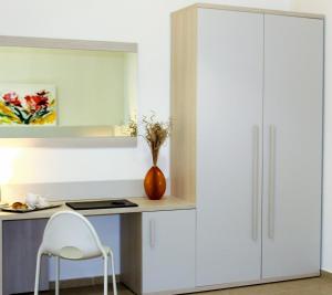 a white cupboard in a room with a desk at Residenza DaMa in Lucera