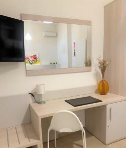 a desk with a mirror and a laptop on it at Residenza DaMa in Lucera