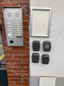 a pay phone on the side of a brick wall at Les spas de la Chartreuse in Tarbes