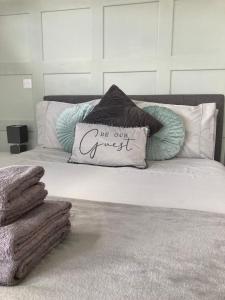 a bed with a pillow that says we are our guest at North Coast Escapes in Thrumster