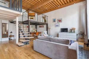 a living room with a couch and a loft at Le Tisserand - Superbe Canut pentes Croix Rousse in Lyon