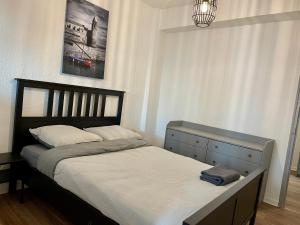 a bedroom with a bed with a black headboard and a window at République - Dauder de Selva in Perpignan