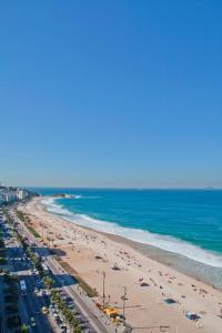 an aerial view of a beach with people and the ocean at Sol Ipanema Hotel in Rio de Janeiro