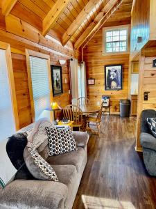 a living room with a couch and a table at Beary Charming in Gatlinburg +9 photos