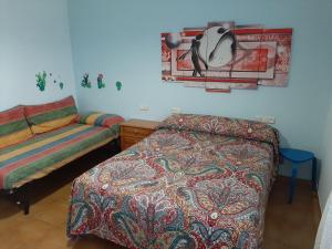 a bedroom with a bed and a bed and a table at Apartamento AS CARBALLAS in Caldas de Reis