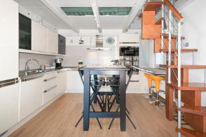 a kitchen with a blue island in the middle at The Boat House Portovenere in Portovenere