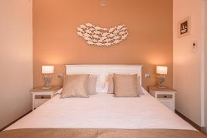 a bedroom with a large bed with two nightstands and two lamps at The Boat House Portovenere in Portovenere