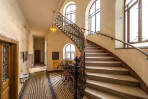 a spiral staircase in an old building with a bike at Schönbrunn Palace Beautiful 1 bedroom apartment in Vienna