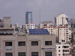 a building with a solar panel on top of it at Eco Hostel in Ramallah
